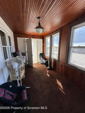 a room with furniture cabinetry and a chandelier