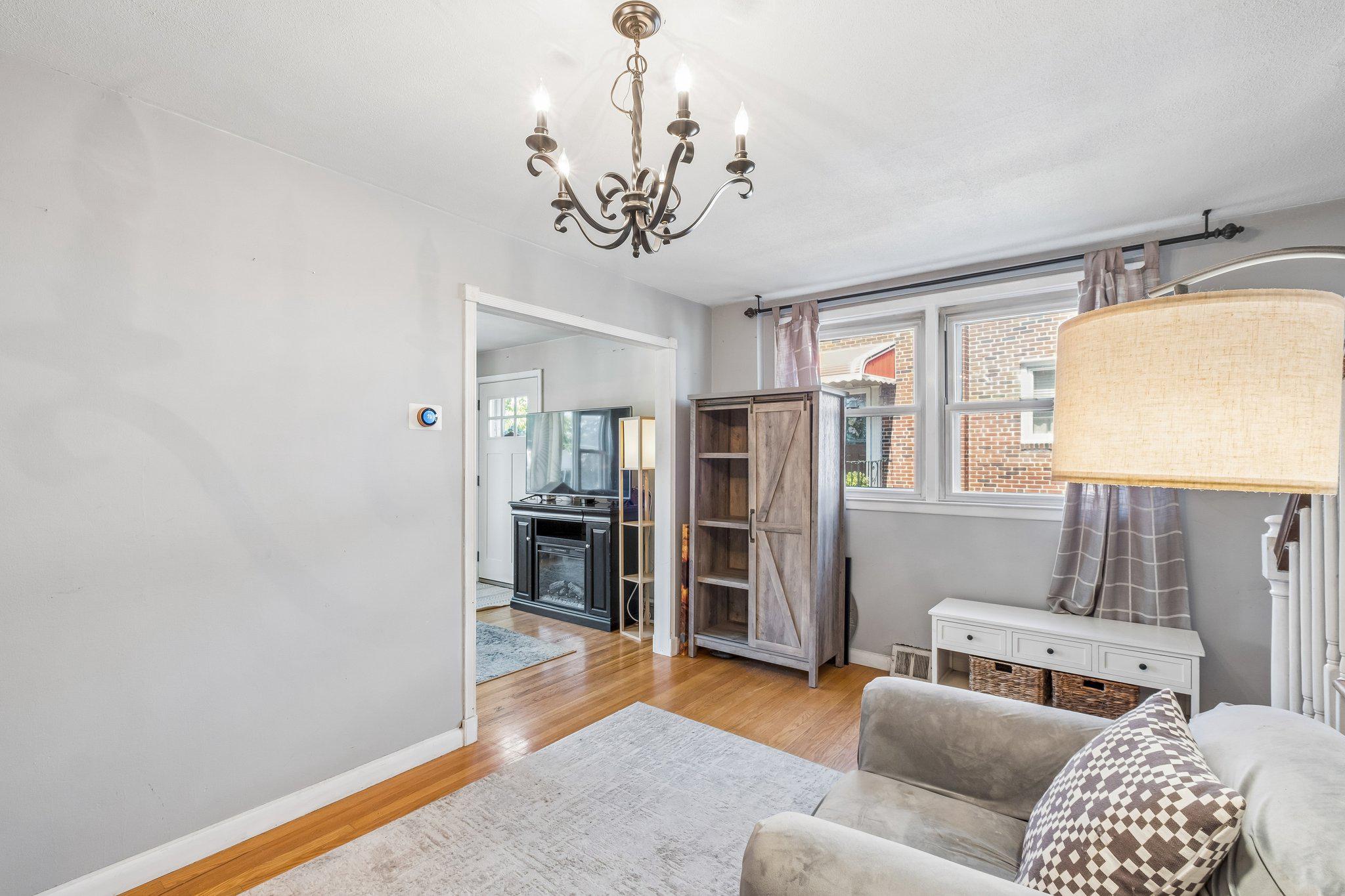 725 Hill Road Philadelphia, PA 19128 - Photo 7 of 43 a living room with furniture and a chandelier