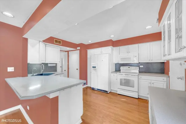 a kitchen with stainless steel appliances a microwave a stove and refrigerator