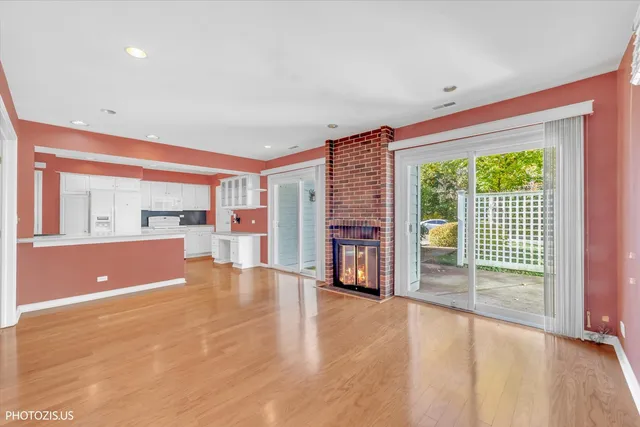 an empty room with floor to ceiling window and an outdoor kitchen