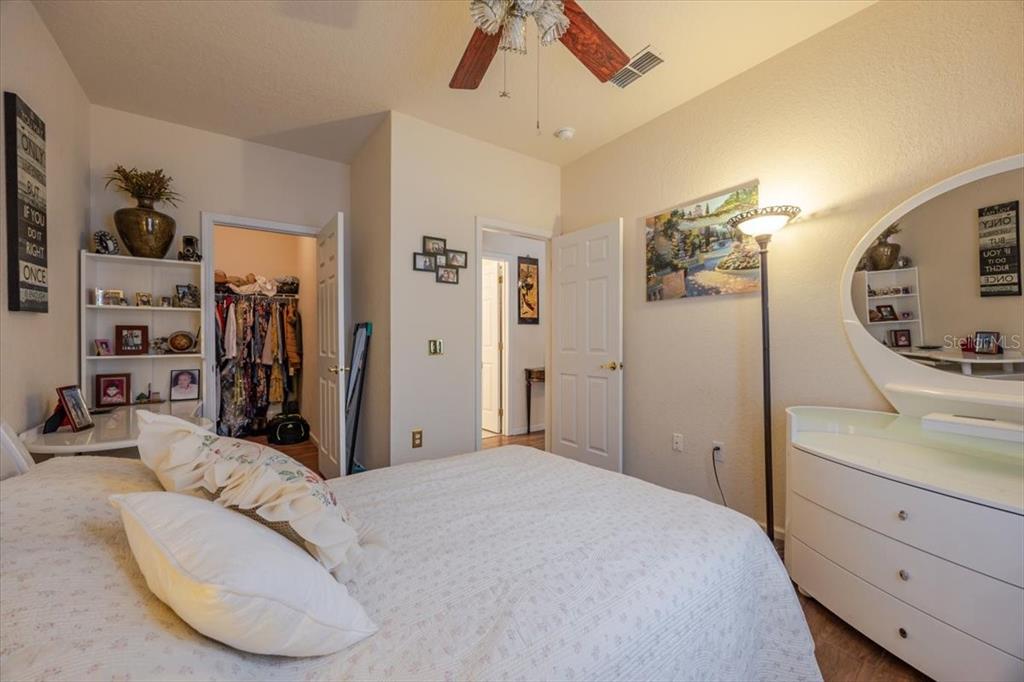 830 Airport Road, Unit 111 Port Orange, FL 32128 - Photo 11 of 21 a bedroom with a bed and a mirror on the dresser