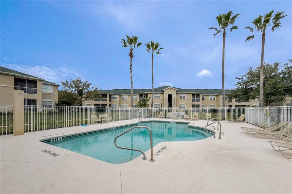 830 Airport Road, Unit 111 Port Orange, FL 32128 - Photo 20 of 21 a swimming pool with outdoor seating and yard