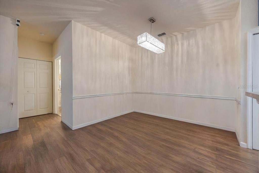 830 Airport Road, Unit 111 Port Orange, FL 32128 - Photo 7 of 21 an empty room with wooden floor and white walls