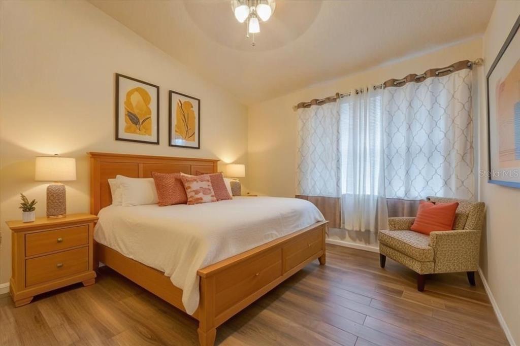 830 Airport Road, Unit 111 Port Orange, FL 32128 - Photo 8 of 21 a bedroom with a bed and a couch