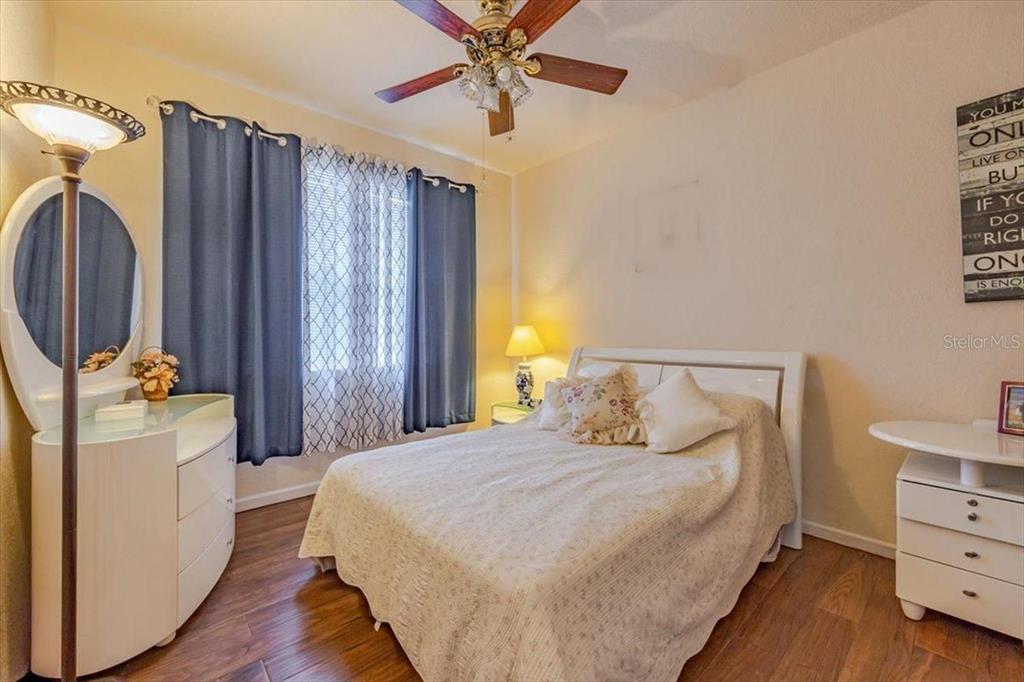 830 Airport Road, Unit 111 Port Orange, FL 32128 - Photo 10 of 21 a bedroom with a bed dresser and a large mirror