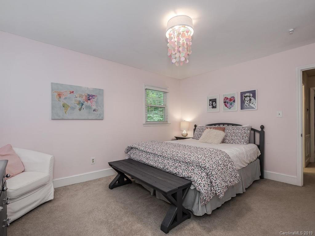 2801 Houston Branch Road Charlotte, NC 28270 - Photo 22 of 31 a spacious bedroom with a bed and a chandelier