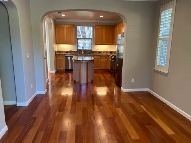 a view of a room with wooden floor and a window