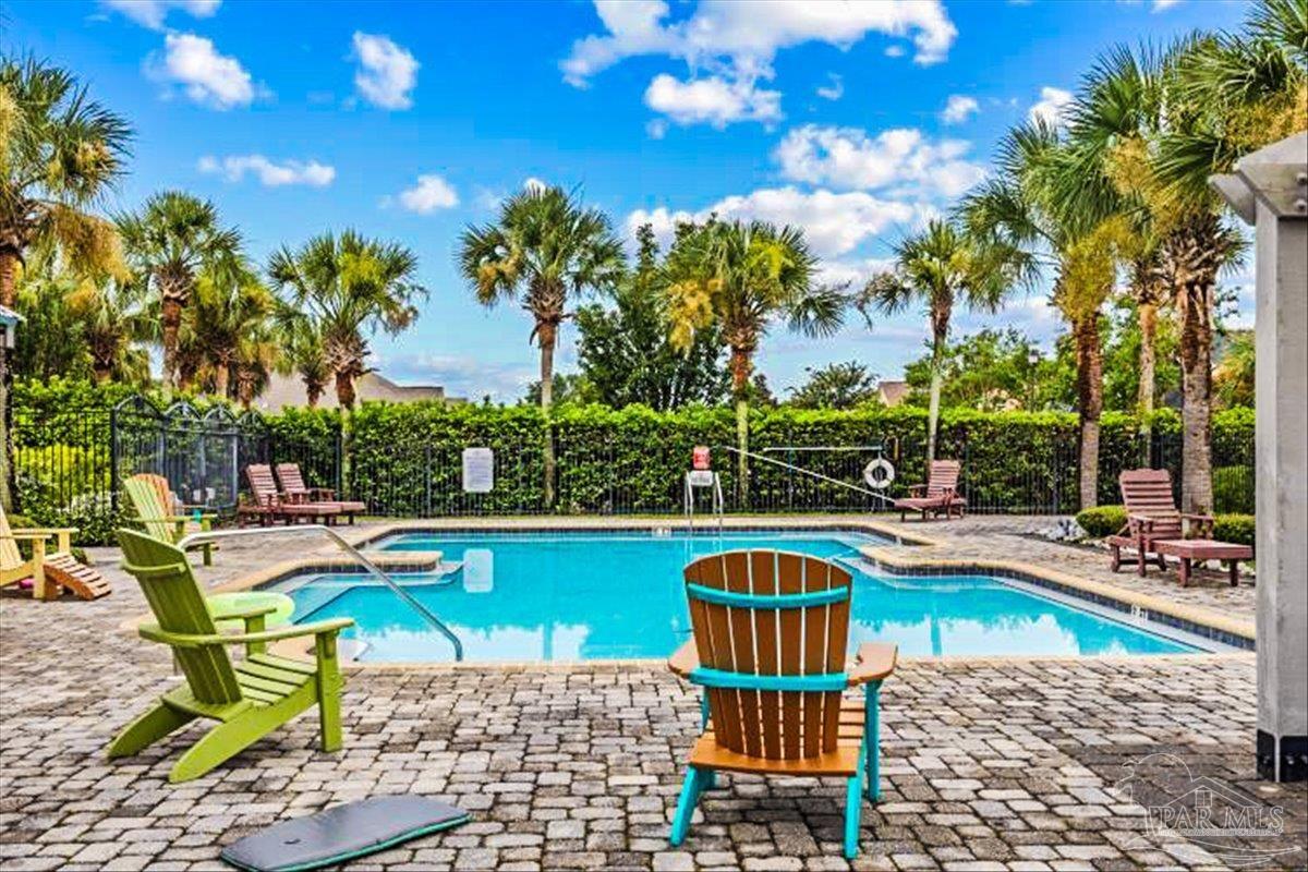 569 Downhaul Drive Pensacola, FL 32507 - Photo 5 of 13 a view of a swimming pool with lounge chairs