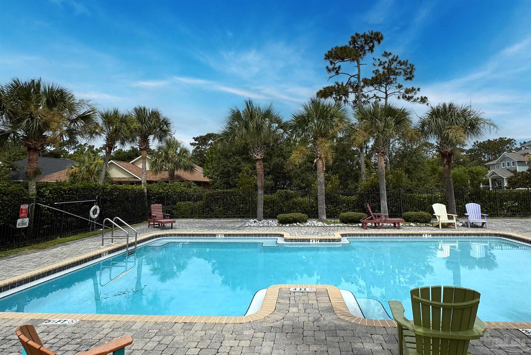 569 Downhaul Drive Pensacola, FL 32507 - Photo 7 of 13 a view of a swimming pool with a lounge chair