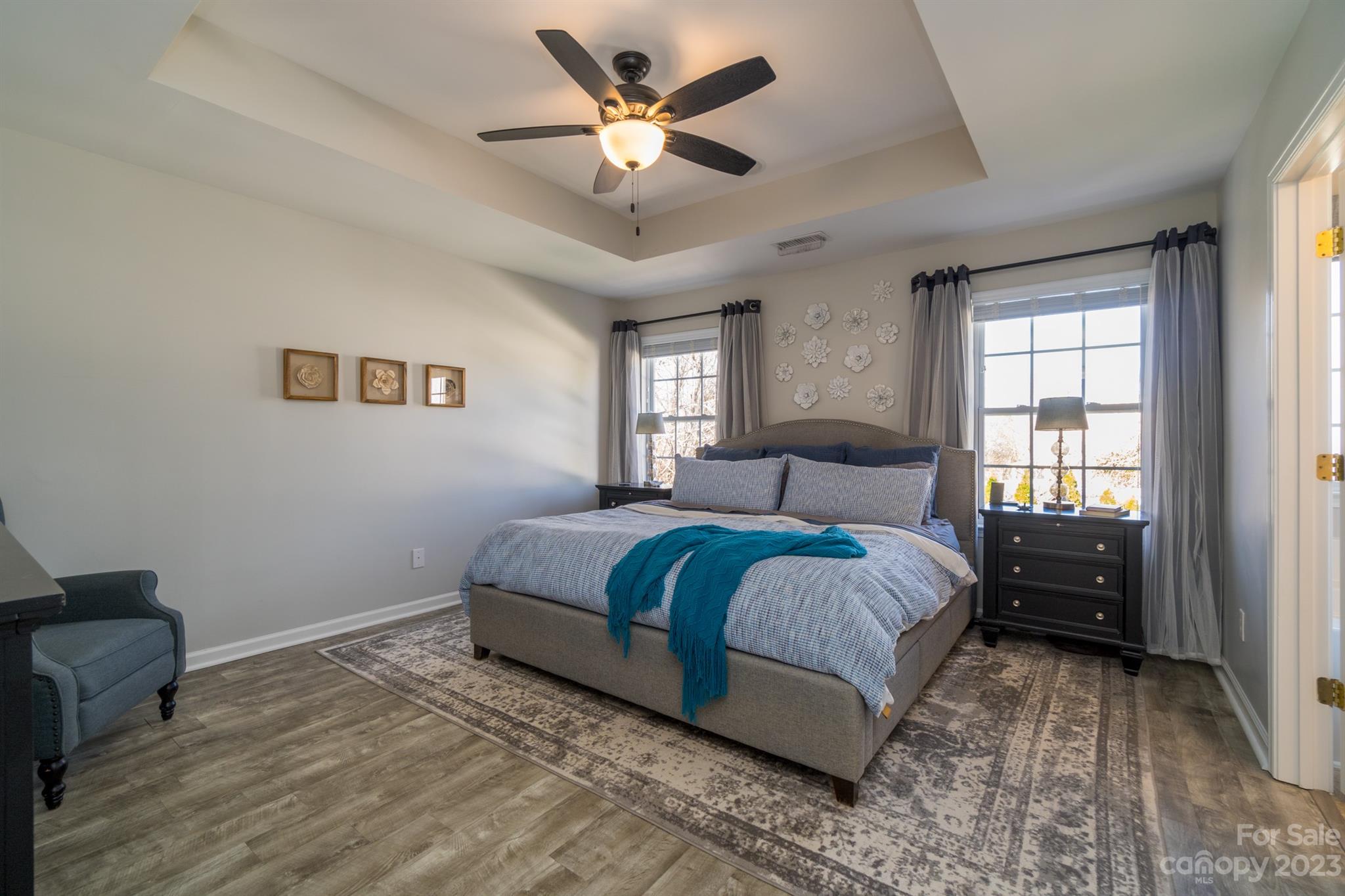 3375 Merchant Lane Davidson, NC 28036 - Photo 13 of 29 a spacious bedroom with a bed and a chandelier