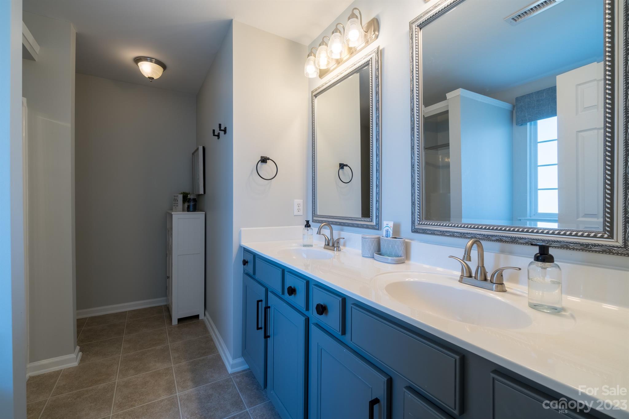 3375 Merchant Lane Davidson, NC 28036 - Photo 15 of 29 a bathroom with a double vanity sink and a mirror
