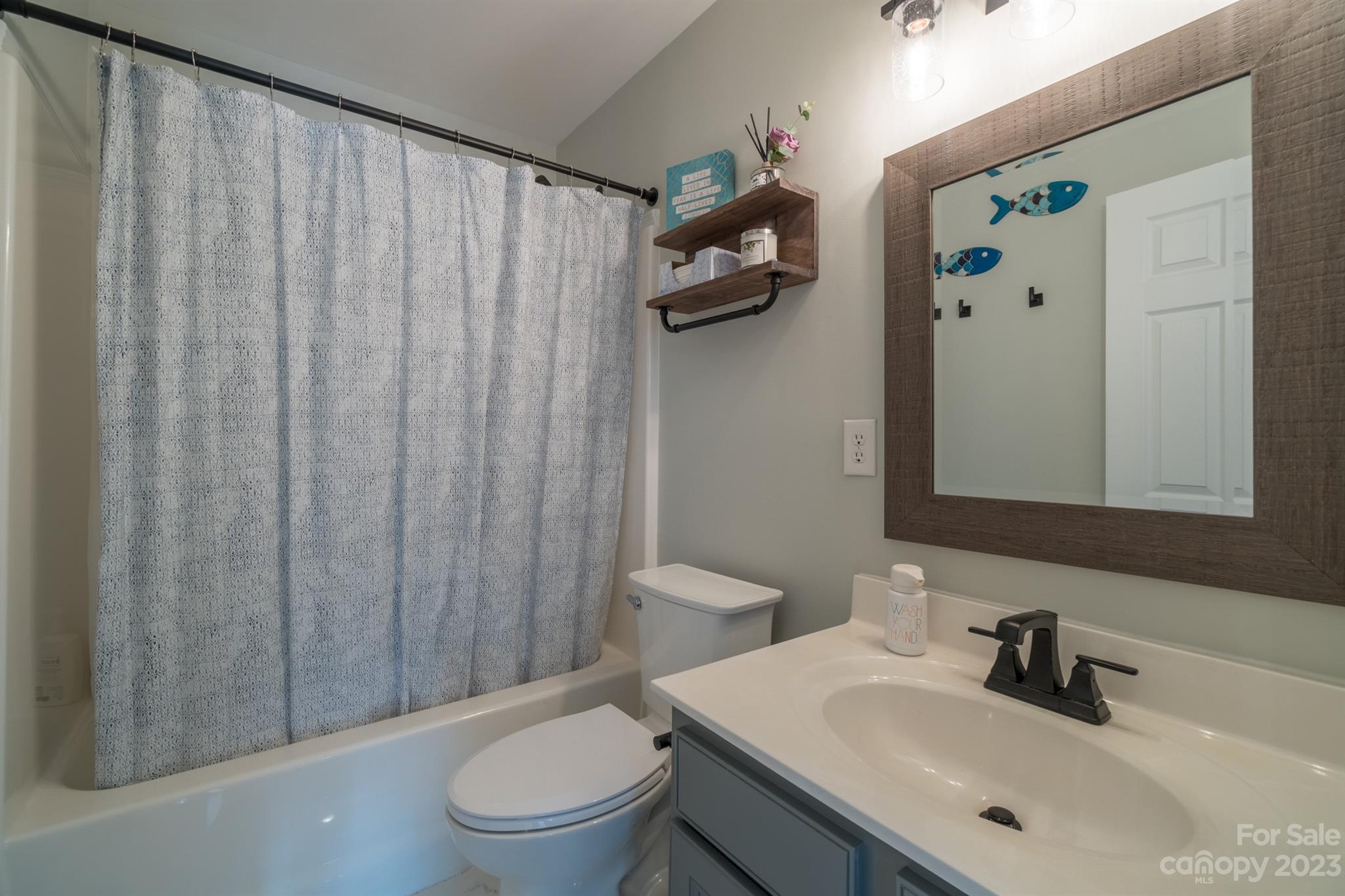 3375 Merchant Lane Davidson, NC 28036 - Photo 20 of 29 a bathroom with a sink a toilet and shower curtain