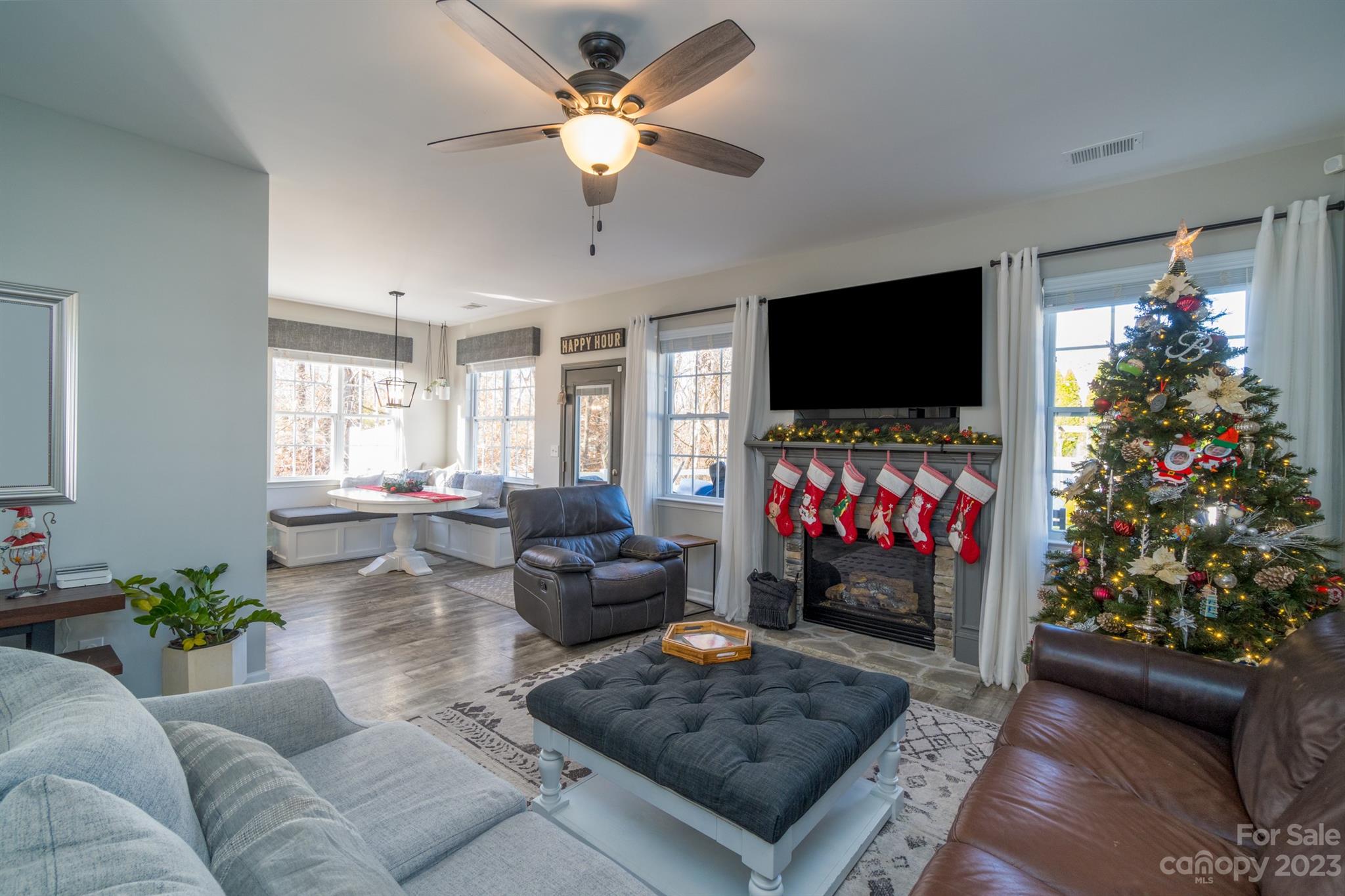3375 Merchant Lane Davidson, NC 28036 - Photo 6 of 29 a living room with furniture a flat screen tv and a fireplace
