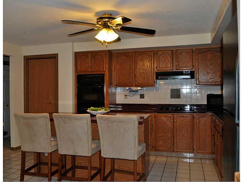296 Sun Mine Road Sarver, PA 16055 - Photo 8 of 25 Kitchen. Large Center Island Kitchen with Ceramic Tile Floor, Lighted Ceiling Fan, Gas Cook Top, Refrigerator, Microwave, Dishwasher, Oven