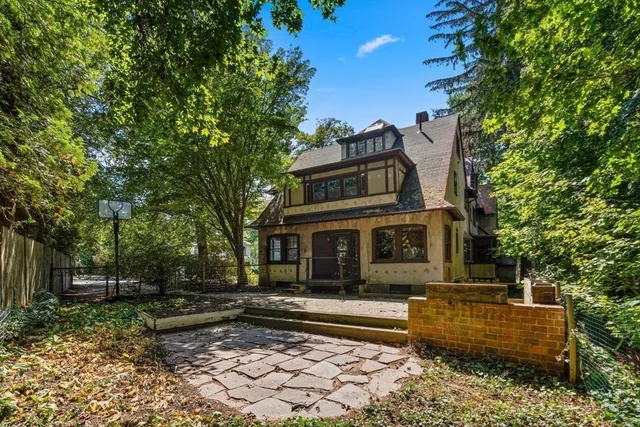a front view of a house with a garden