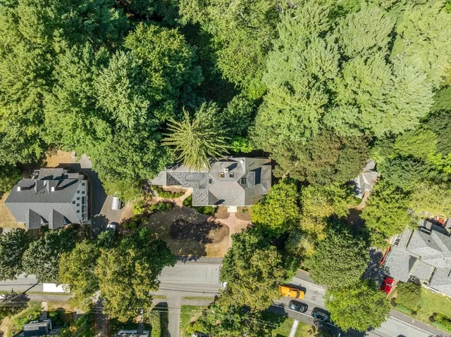an aerial view of a house with a yard