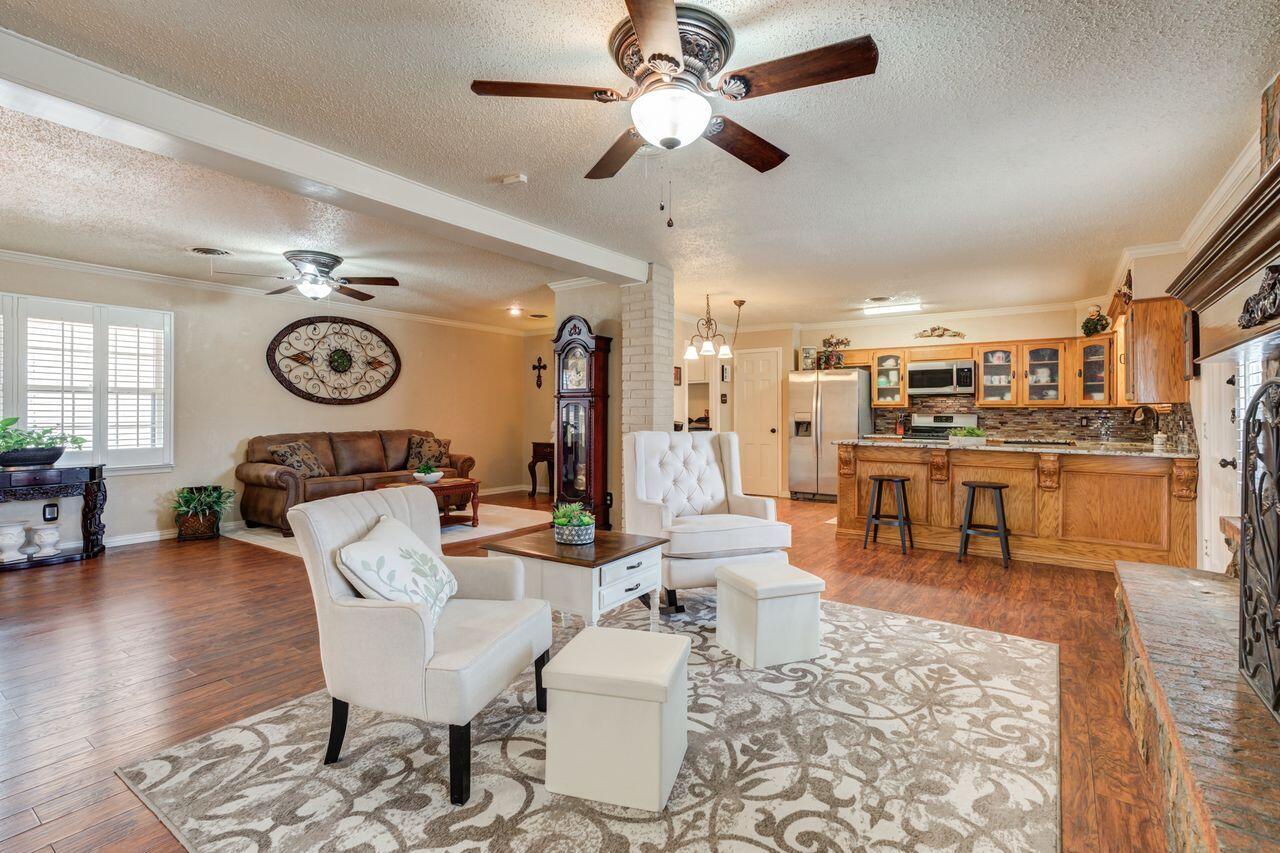 4904 18th Street Lubbock, TX 79416 - Photo 13 of 39 a living room with lots of furniture and kitchen view