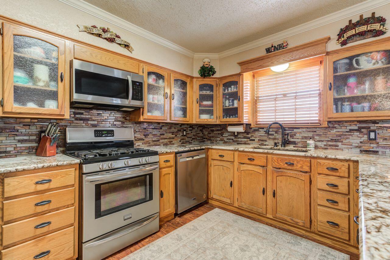 4904 18th Street Lubbock, TX 79416 - Photo 19 of 39 a kitchen with stainless steel appliances a stove sink and microwave