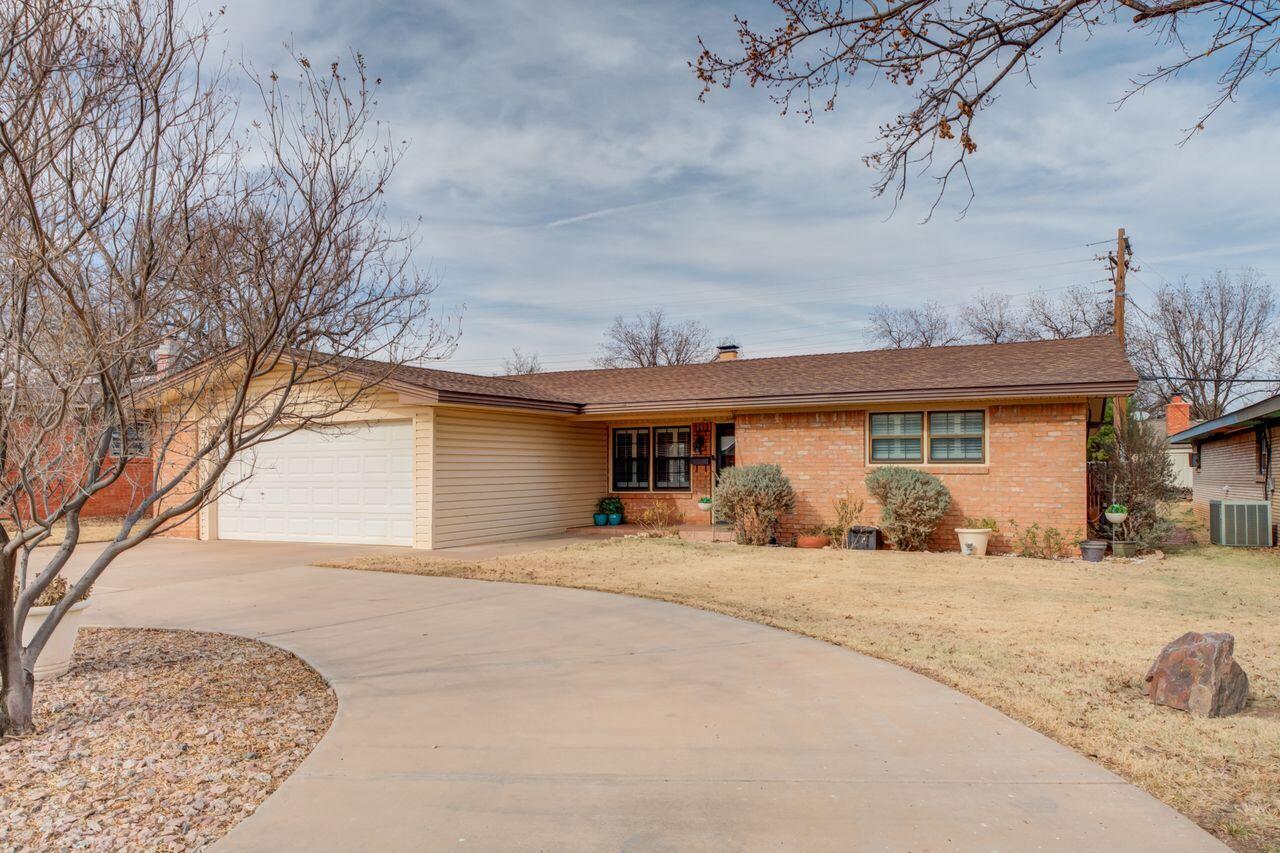 4904 18th Street Lubbock, TX 79416 - Photo 2 of 39 a house with trees in front of it