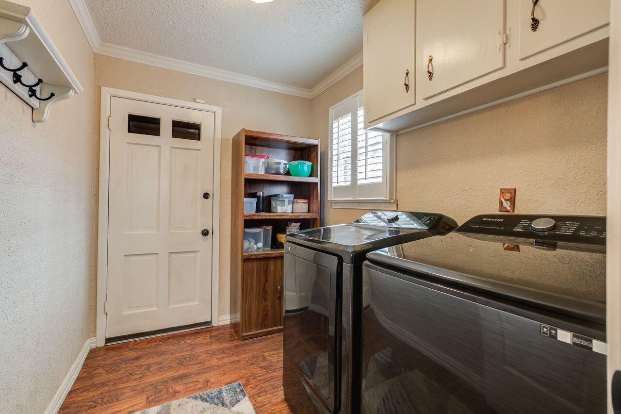 4904 18th Street Lubbock, TX 79416 - Photo 23 of 39 a utility room with stainless steel appliances granite countertop a stove and a refrigerator