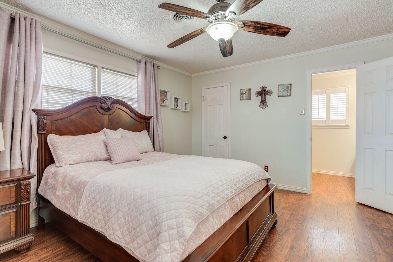4904 18th Street Lubbock, TX 79416 - Photo 30 of 39 a bedroom with a bed and wooden floor