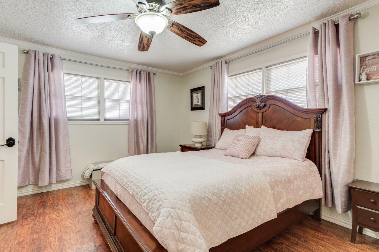 4904 18th Street Lubbock, TX 79416 - Photo 31 of 39 a bedroom with a bed and wooden floor