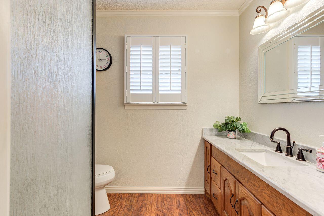 4904 18th Street Lubbock, TX 79416 - Photo 32 of 39 a bathroom with a sink and a toilet