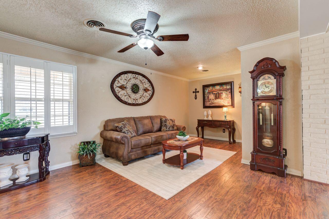 4904 18th Street Lubbock, TX 79416 - Photo 6 of 39 a living room with furniture a clock and a window