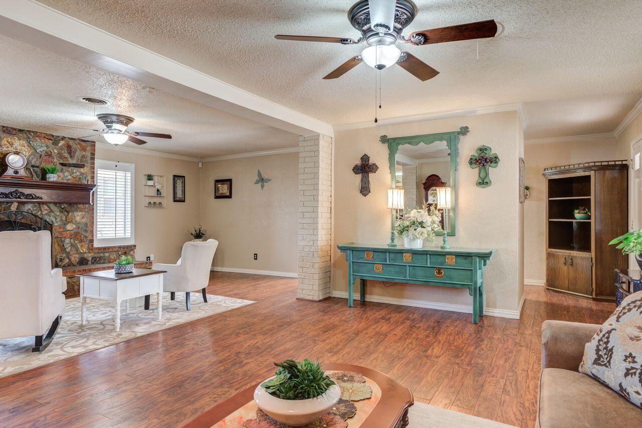4904 18th Street Lubbock, TX 79416 - Photo 9 of 39 a living room with furniture and a wooden floor