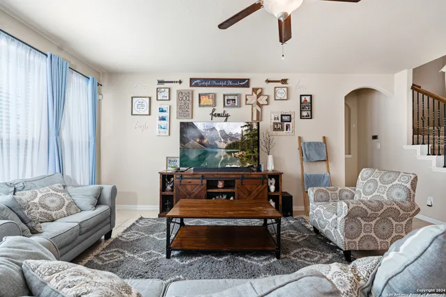 a living room with furniture and a large window