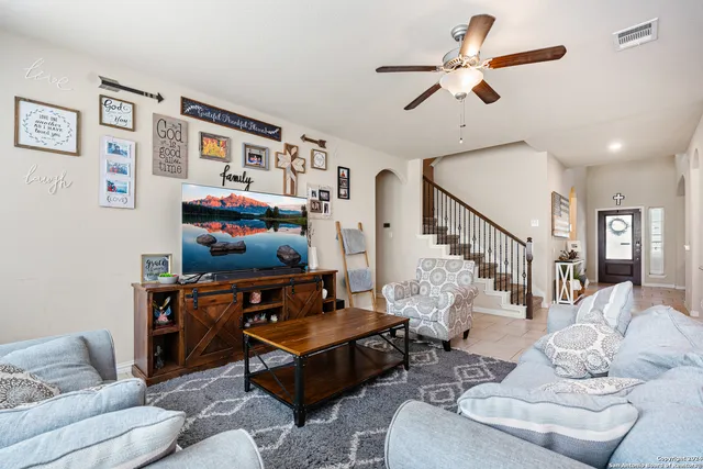 a living room with furniture and a flat screen tv