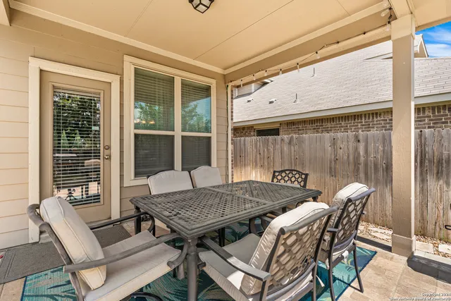 a view of a patio with table and chairs and potted plants