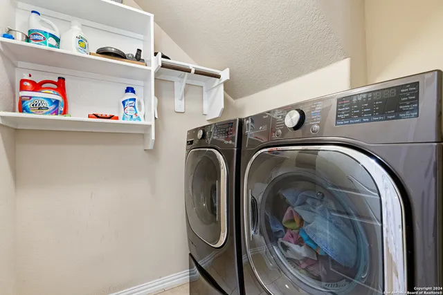 a kitchen with granite countertop kitchen island stainless steel appliances sink stove microwave and cabinets