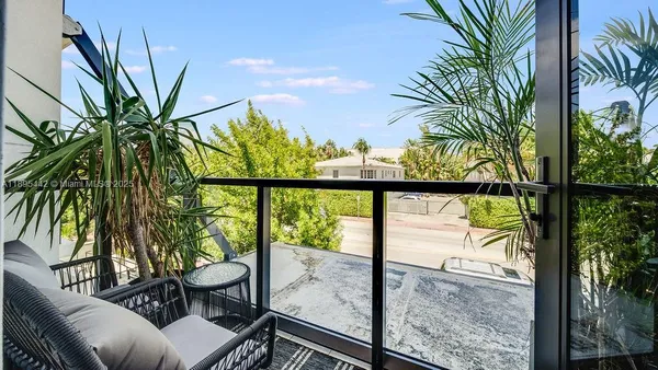 a view of a balcony with lake view and a potted plant