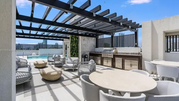 a swimming pool with outdoor seating and yard