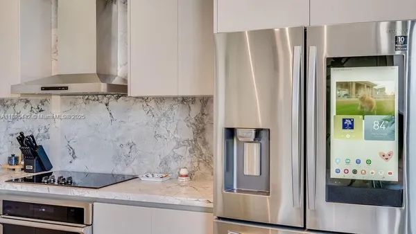 a kitchen with a refrigerator and a stove