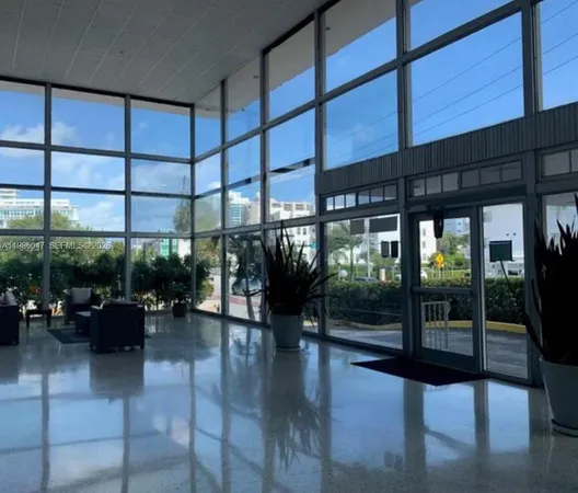 a lobby with furniture and floor to ceiling window