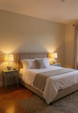 a bedroom with a bed and lamps