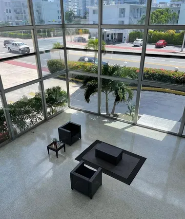 a room with pool table and glass windows