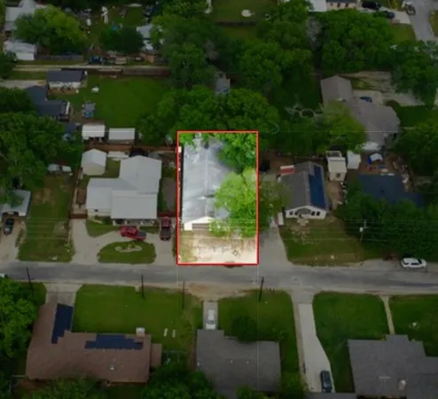 an aerial view of a house with outdoor space and street view