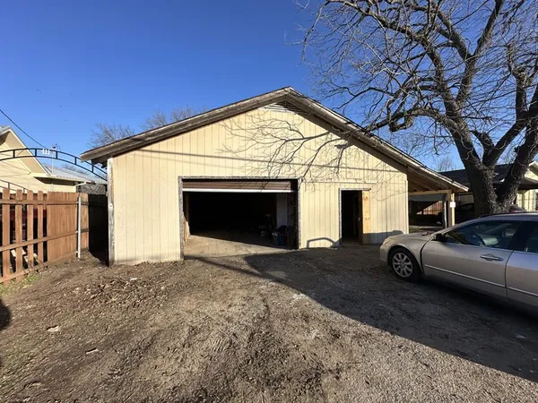 a view of garage with a car parked in it