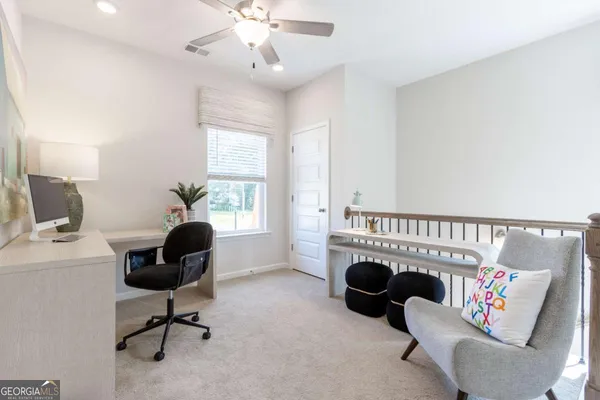 a view of a livingroom with workspace and a couch