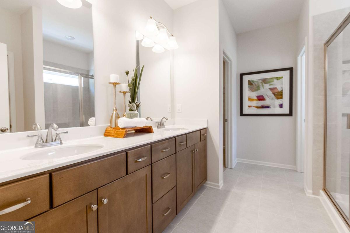 1434 Trellis Court, Unit (LOT 24) Hampton, GA 30228 - Photo 23 of 34 a bathroom with a double vanity sink and a mirror