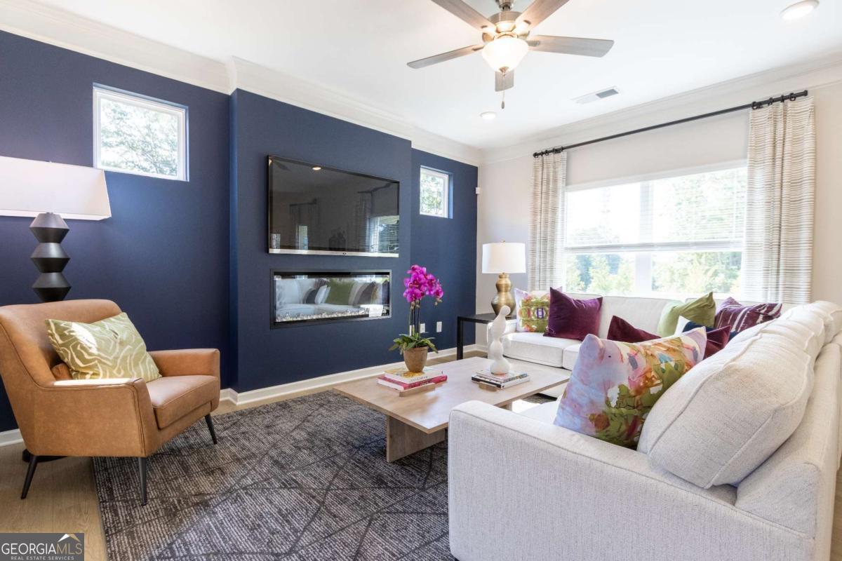 1434 Trellis Court, Unit (LOT 24) Hampton, GA 30228 - Photo 3 of 34 a living room with furniture and a window