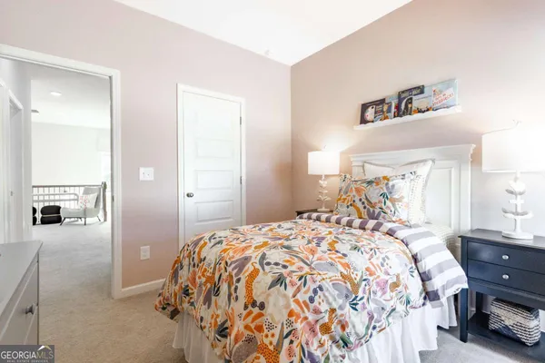a bedroom with a bed and a mirror