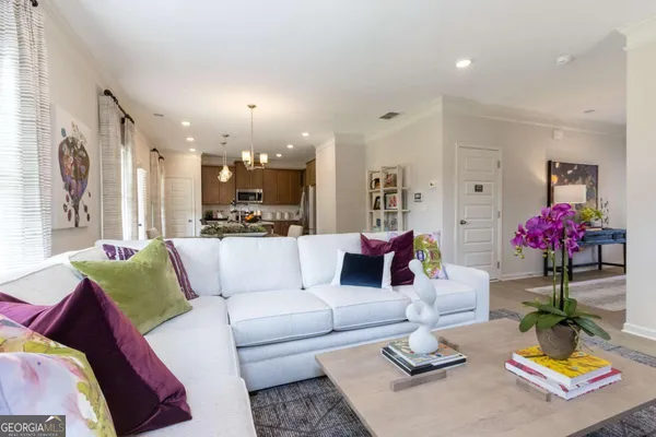 a living room with furniture and a chandelier