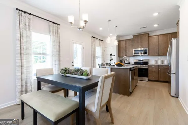 a kitchen with kitchen island a table and chairs in it