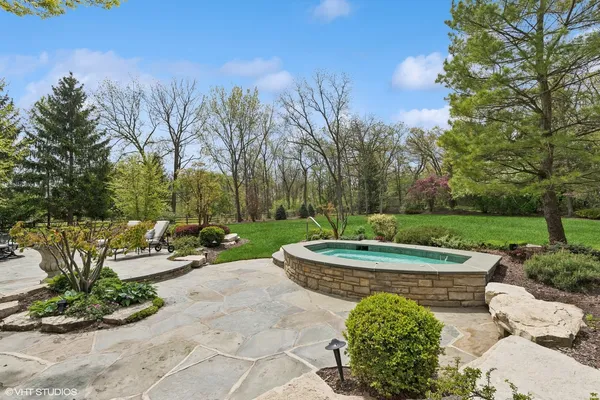 a view of a garden with large trees