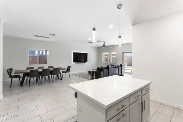 a living room with furniture and a view of kitchen