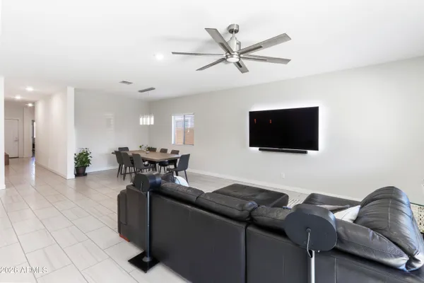 a bedroom with a bed and a ceiling fan